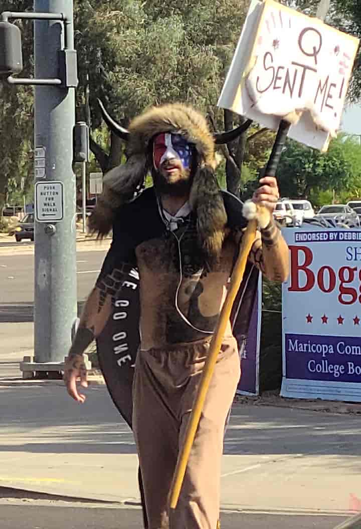 Jake Angeli (Qanon Shamon), seen holding a Qanon sign at the intersection of Bell Rd and 75th Ave in Peoria, Arizona, on 2020 October 15