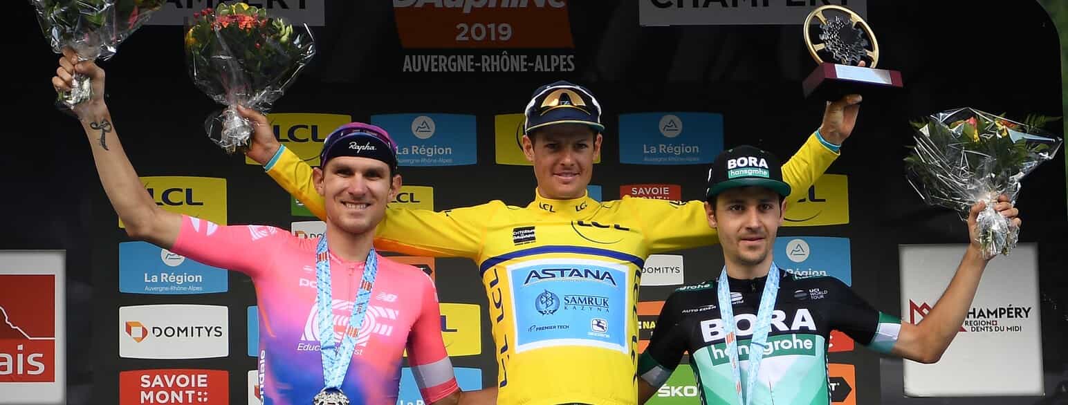 Jakob Fuglsang (i midten) hyldes som vinder af Critérium du Dauphiné i 2019
